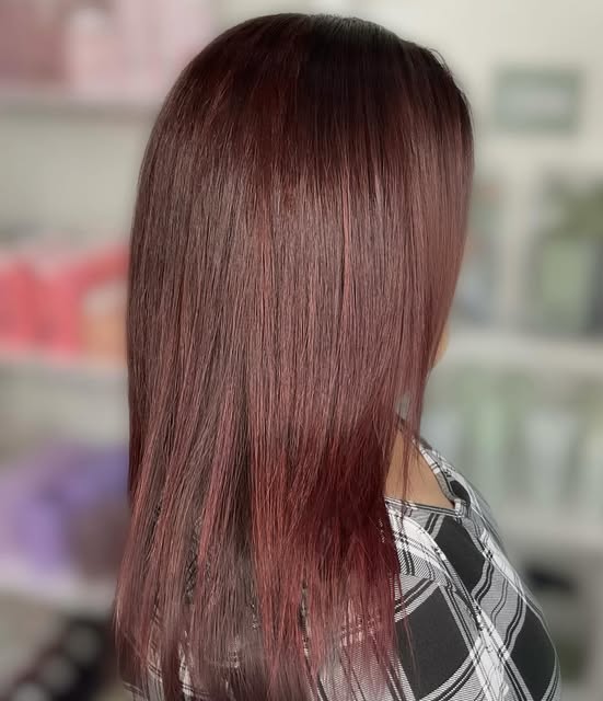 Straight, shoulder-length hair in a rich red-brown shade